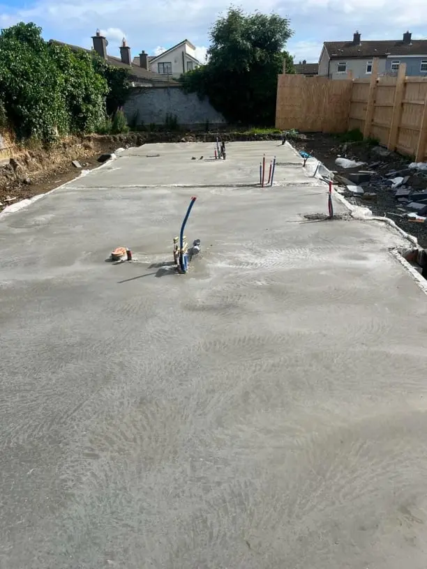 Freshly poured concrete slab for a residential rear extension