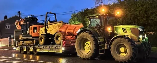 Excavator loaded on a low-loader trailer ready for transport