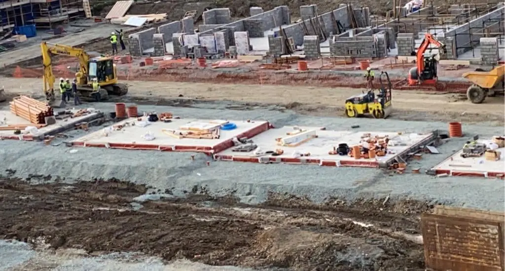 Housing build in progress with Komatsu excavators and block walls