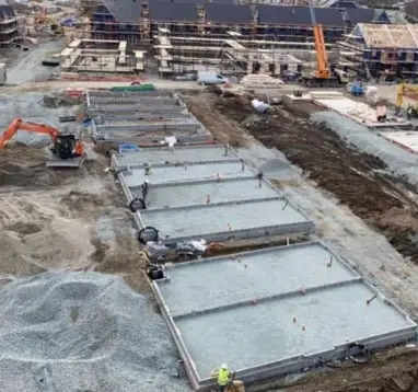 Aerial view of a housing development with concrete foundation slabs