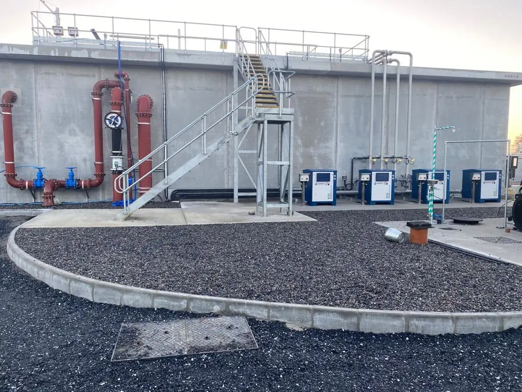 Wastewater treatment plant building with exposed process pipework